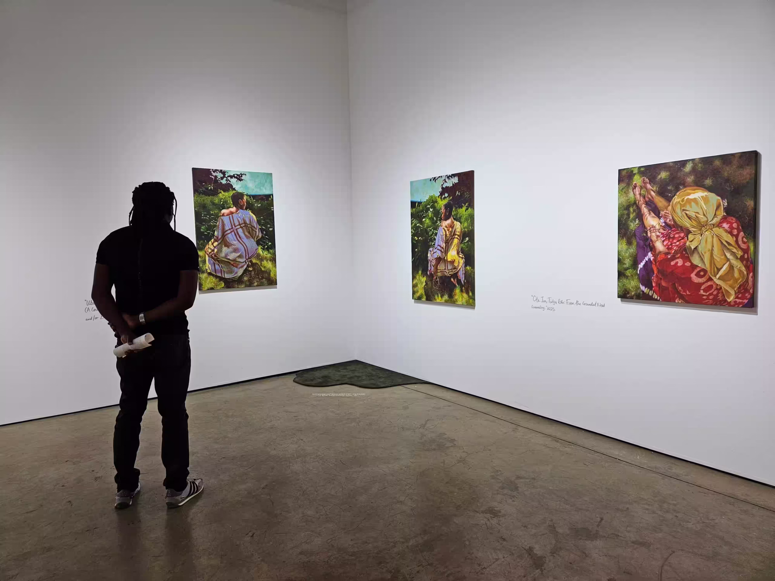 A visitor to The African Arts Trust observes art installations from the Fabric of our Being collection by April Kamunde