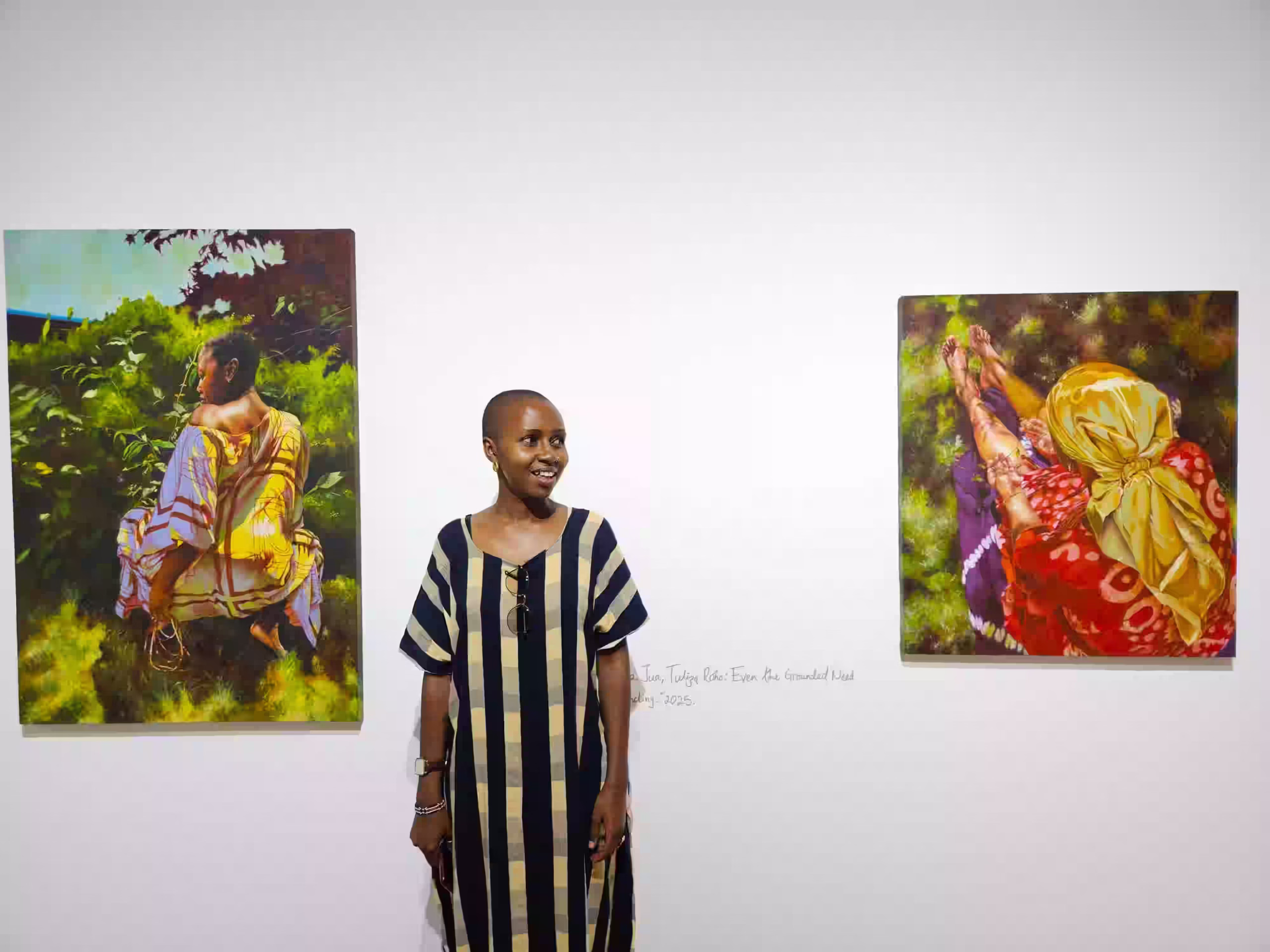 April Kamunde poses next to two of her art pieces in the collection titled Fabric of our being at The African Art Trust